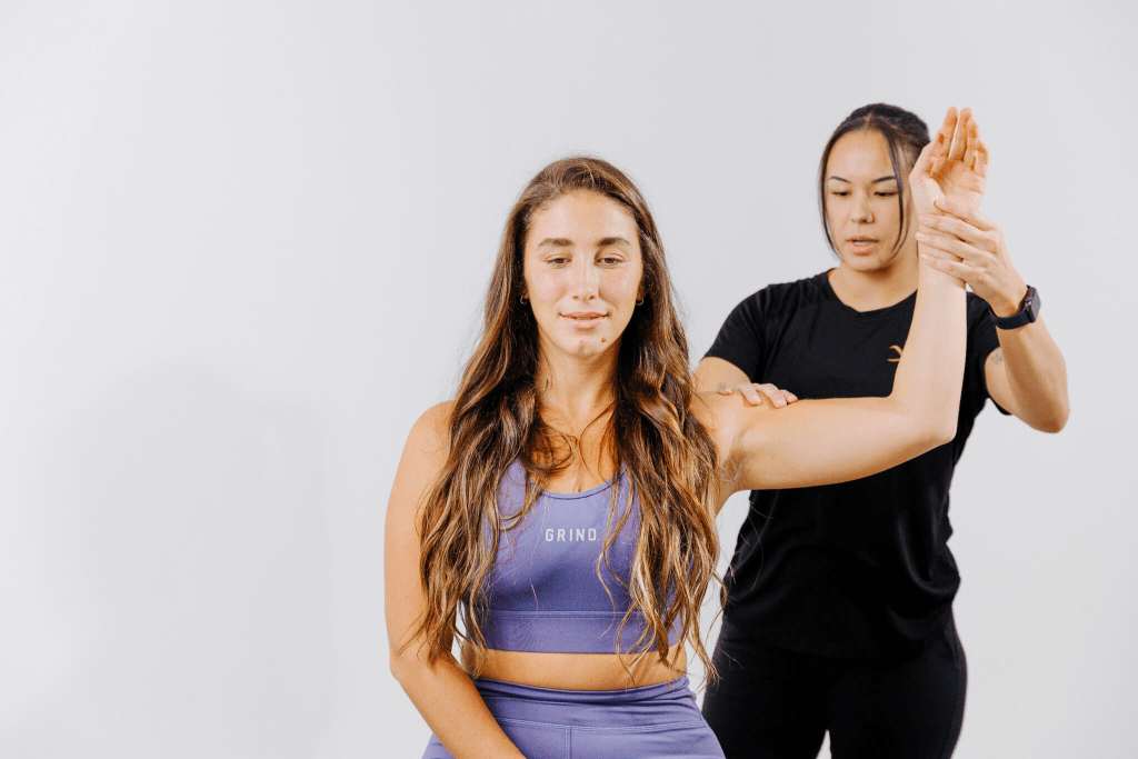 Massage therapist treating shoulder impingement with focused therapy.